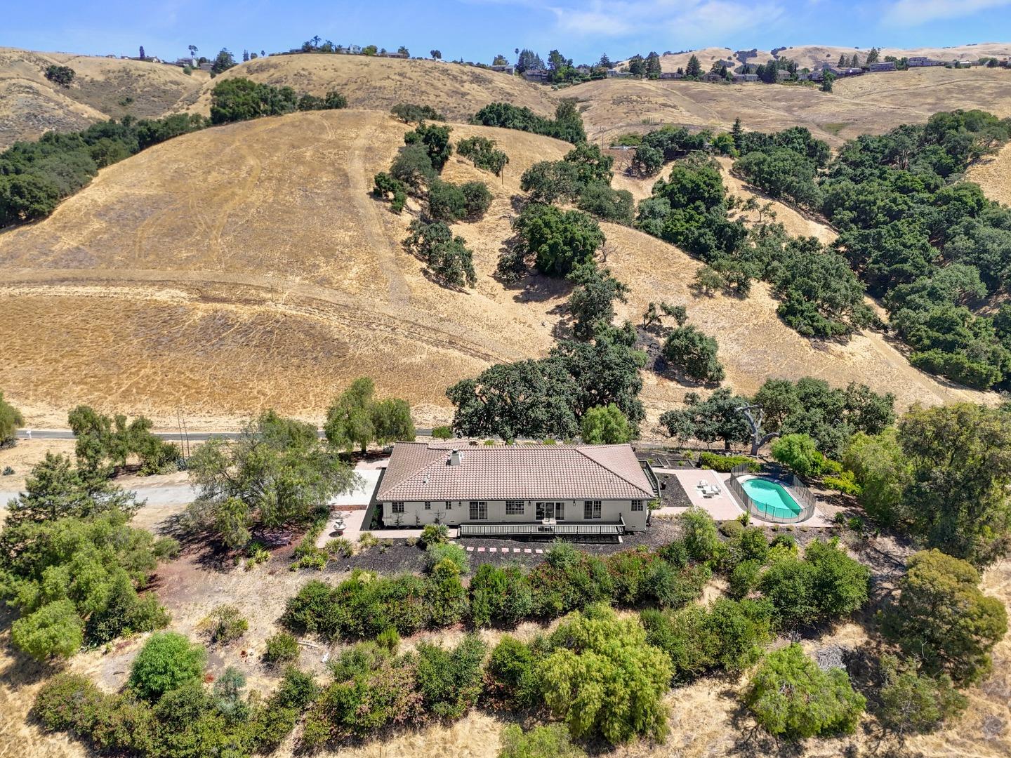 an aerial view of a house with a yard and lake view