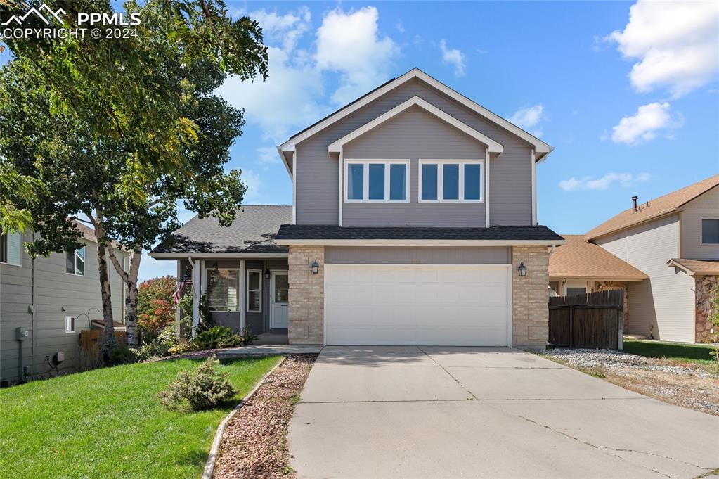 a front view of a house with a yard and garage