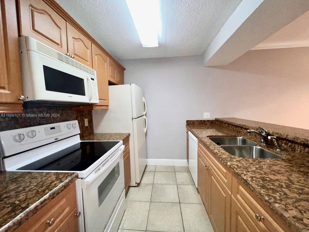 a kitchen with stainless steel appliances granite countertop a stove and a microwave