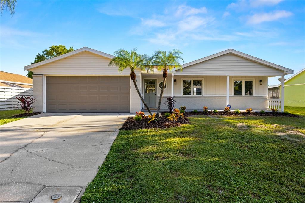 a front view of house with yard and green space