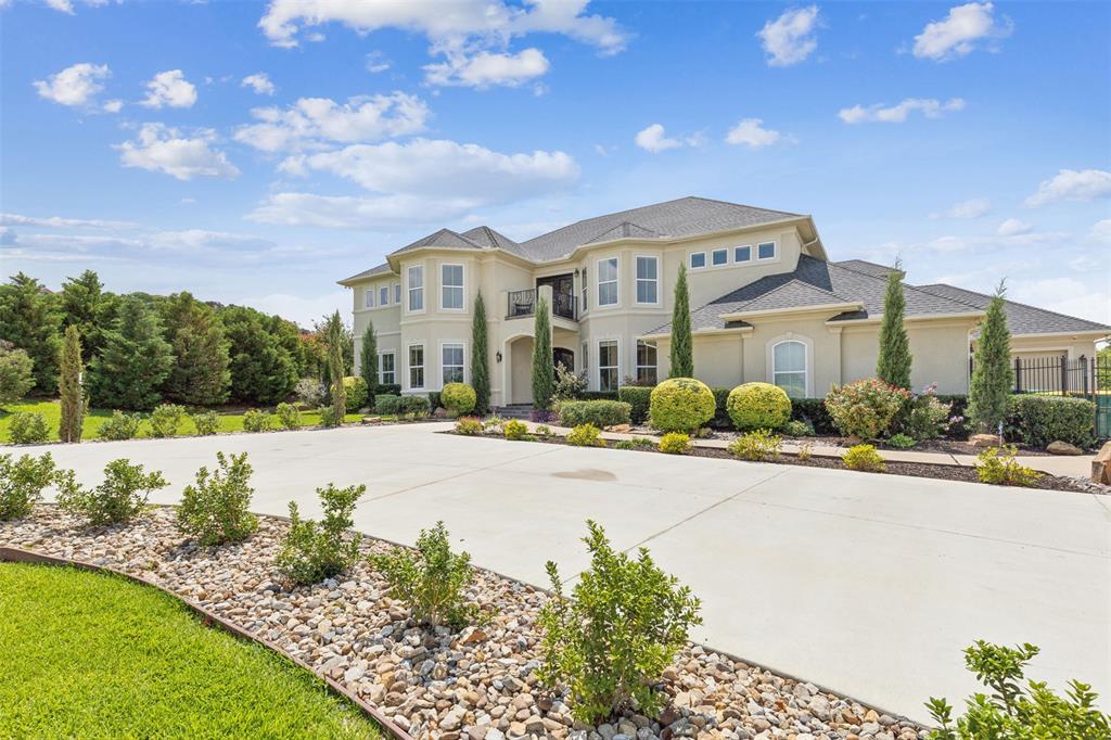 a front view of a house with yard and green space