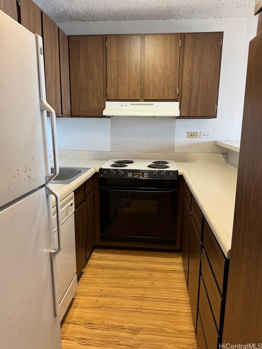 a kitchen with a stove and a refrigerator