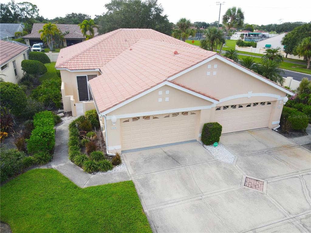 a aerial view of a house with yard and mountain view in back