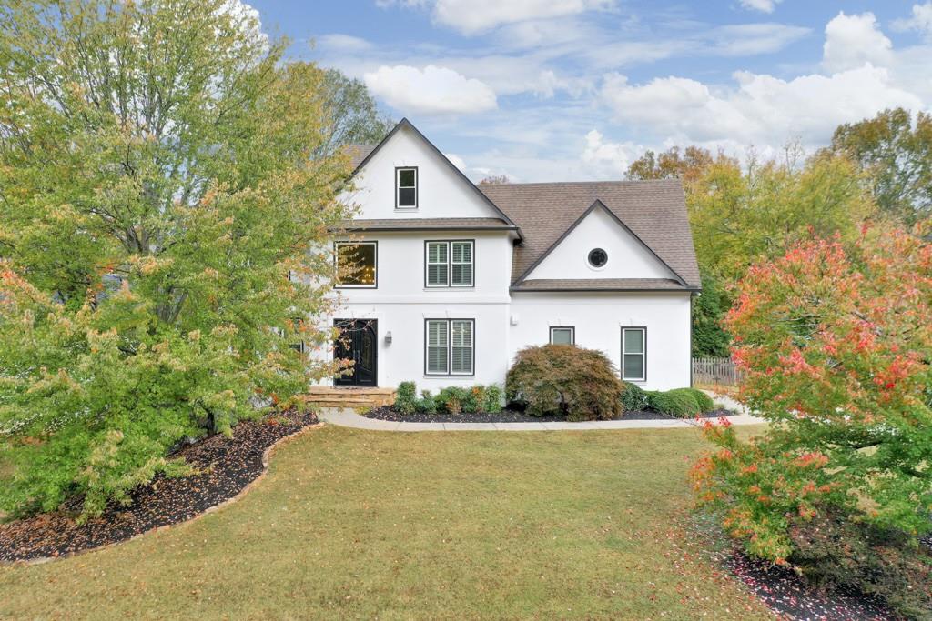 a front view of a house with a yard