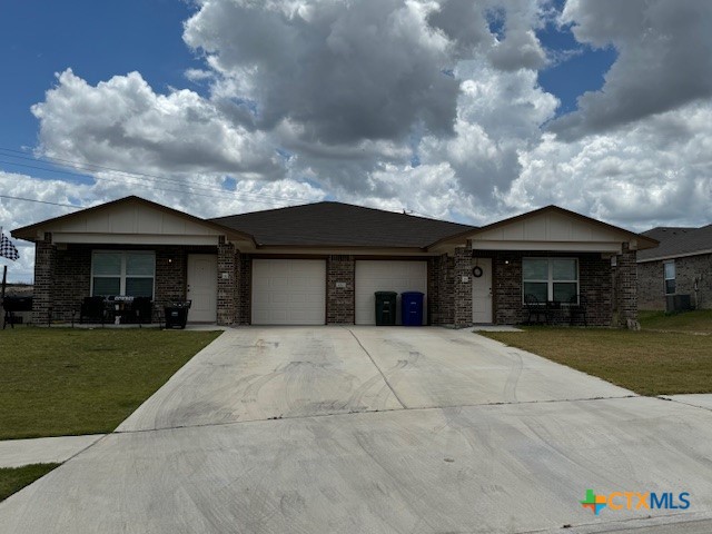 a front view of house with yard and green space