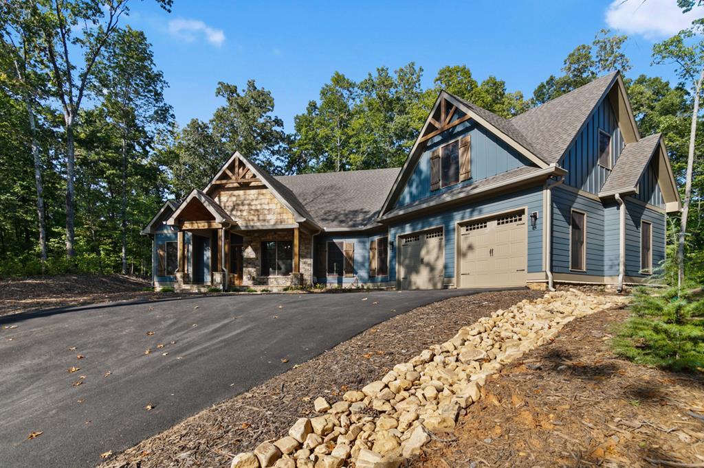 a view of a house next to a yard with road