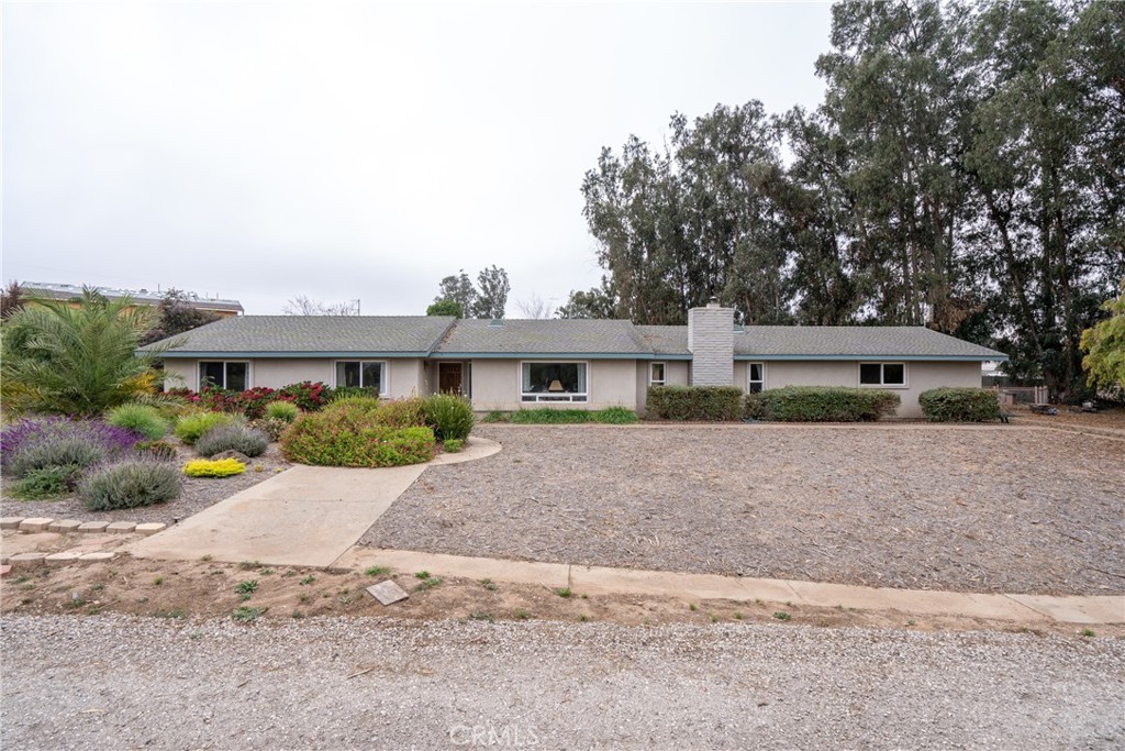 a front view of a house with a yard and a garage