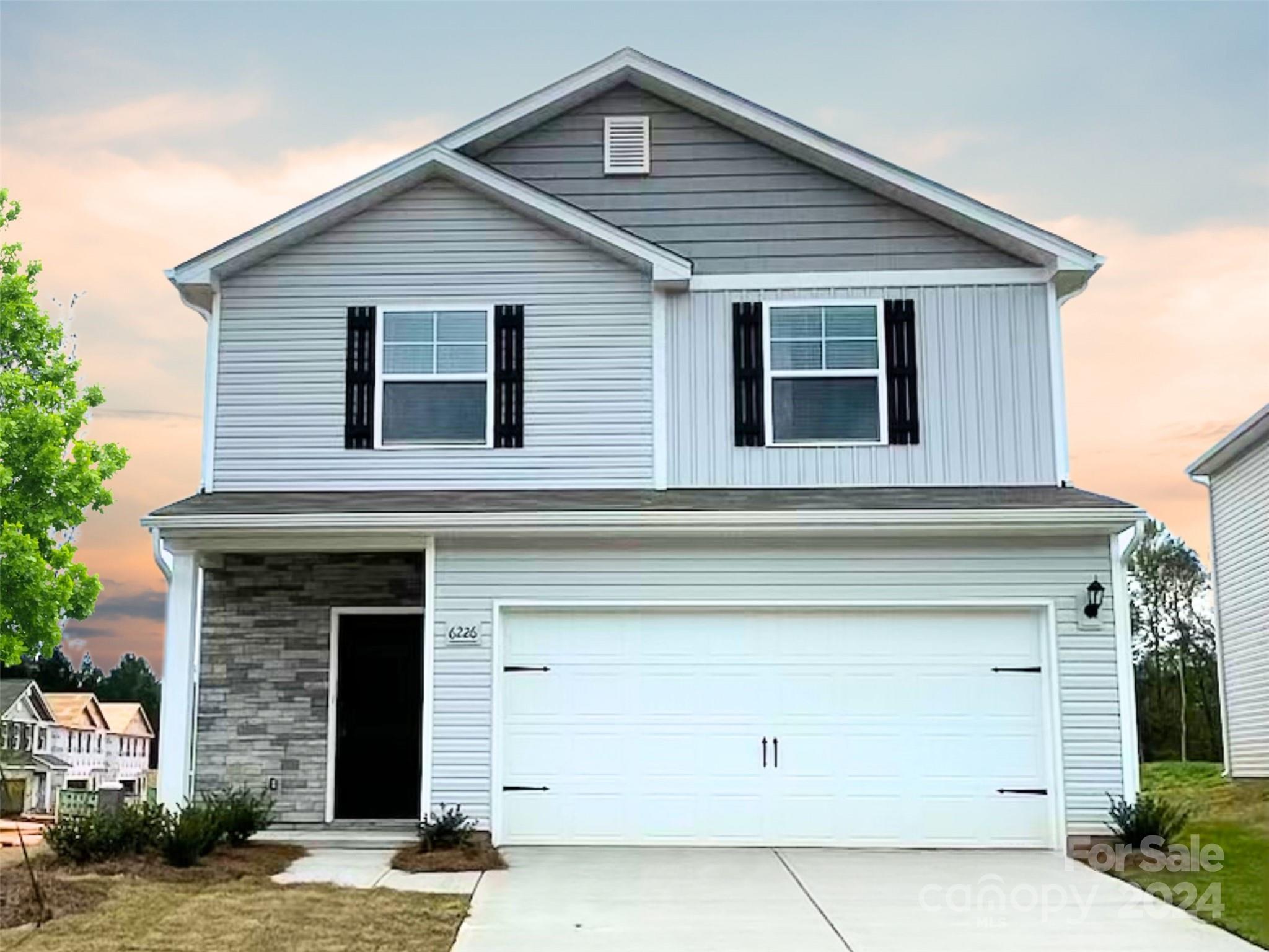 a front view of a house with a garage