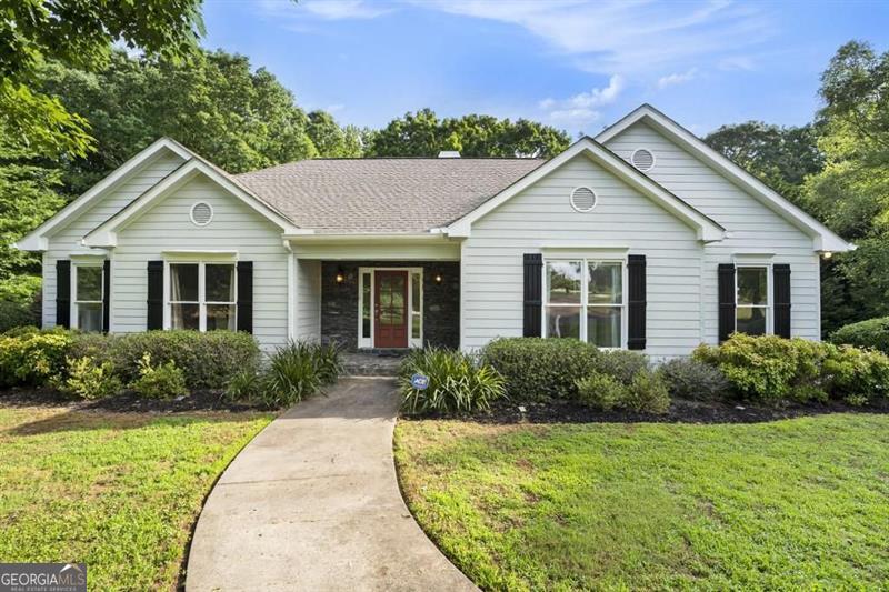 a front view of a house with garden