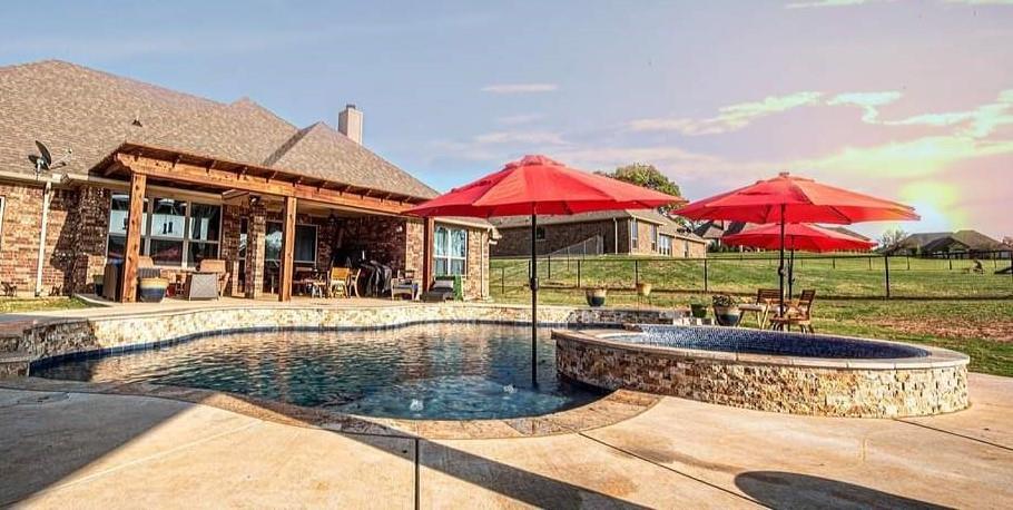 a view of a house with swimming pool and sitting area