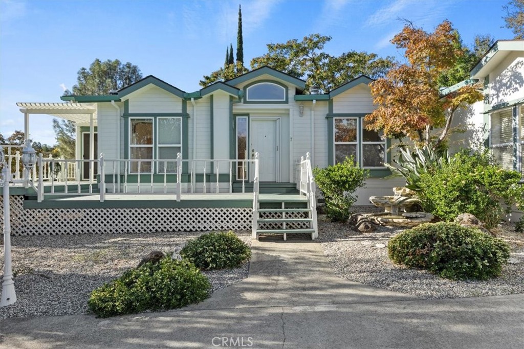 a front view of a house with a garden