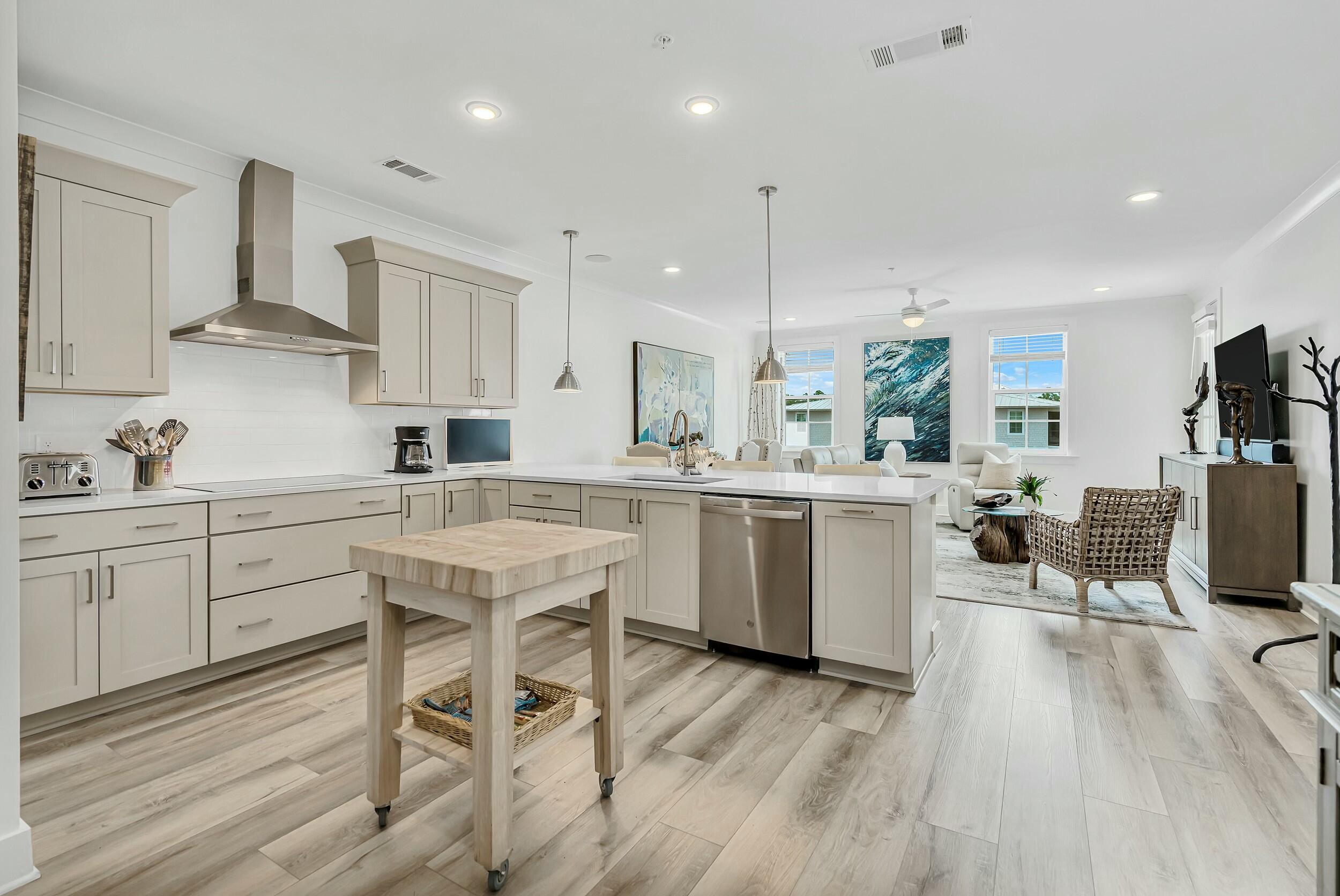 a kitchen with a table chairs refrigerator and cabinets