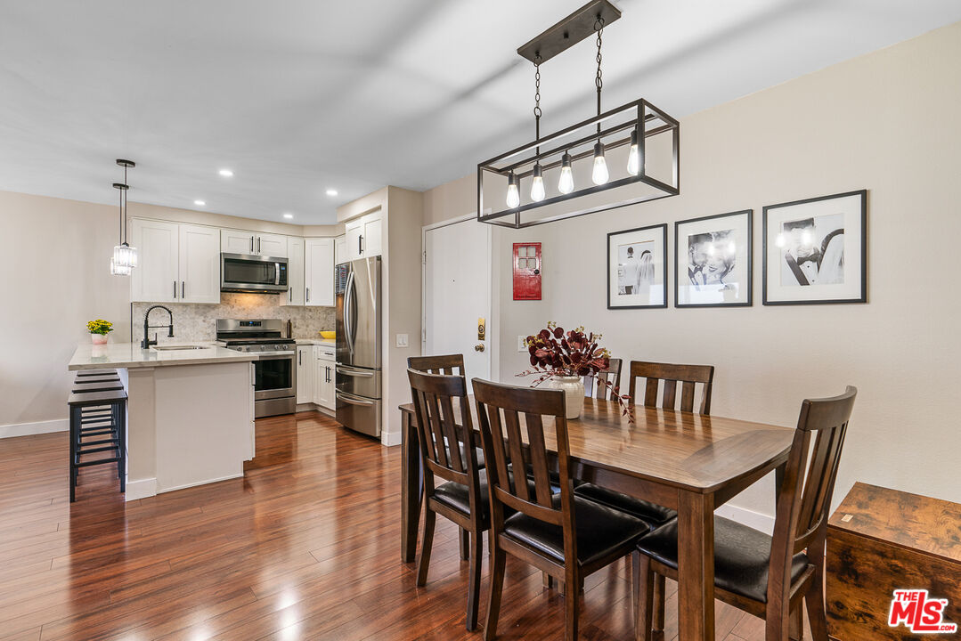 a view of a dining room with furniture kitchen and chandelier