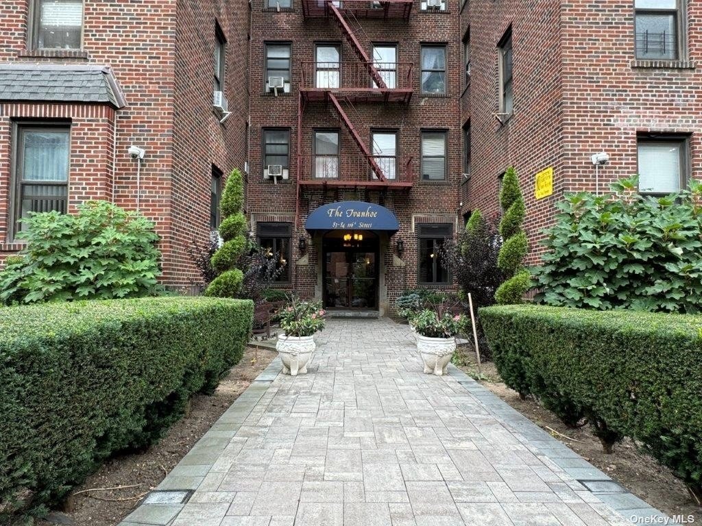 a front view of a building with garden