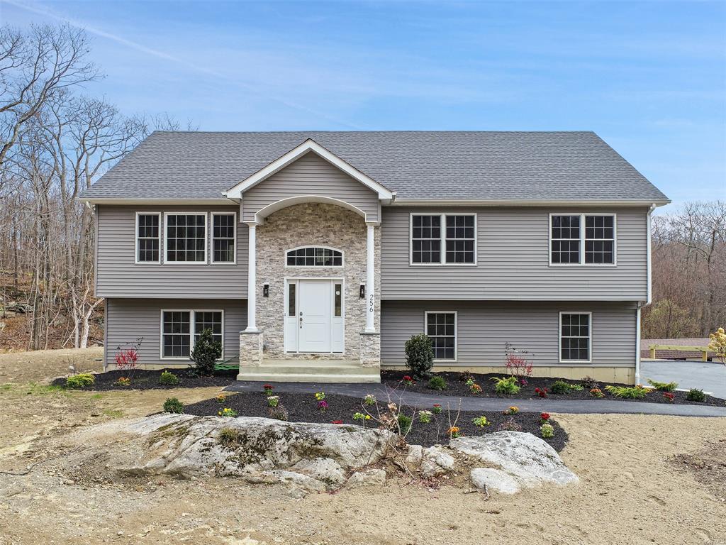 a front view of a house with a yard