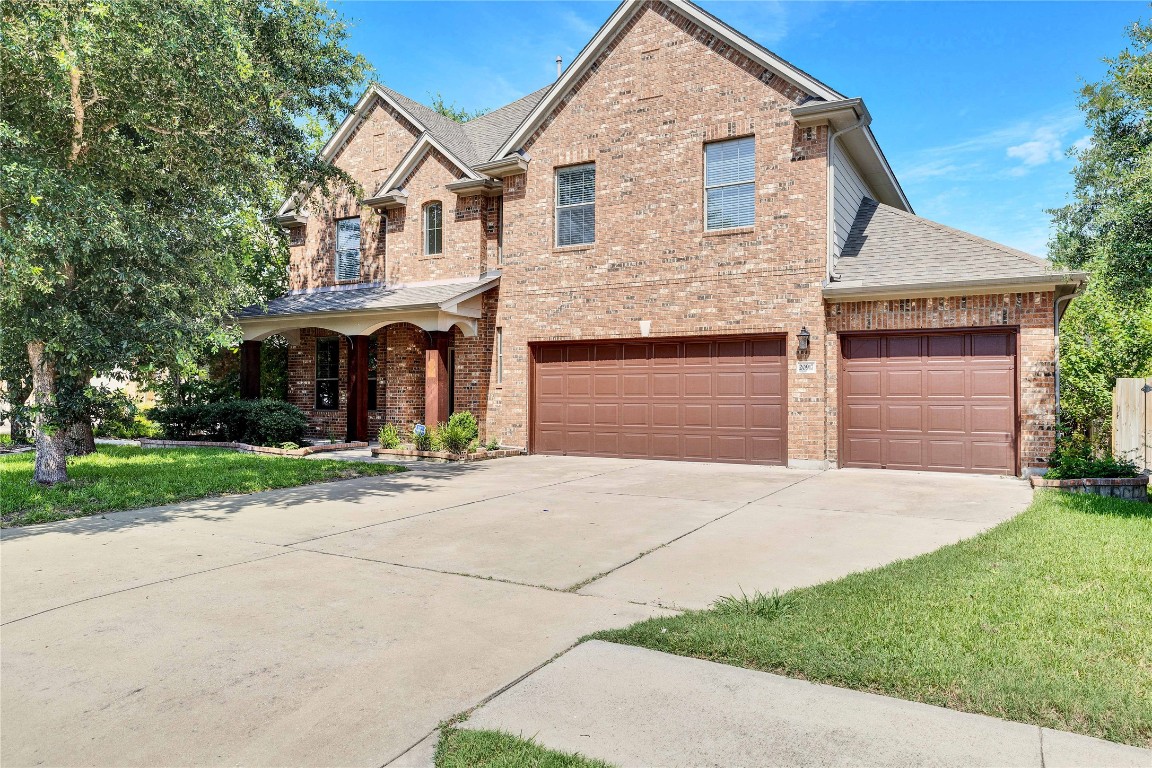 a front view of a house with a yard and garage