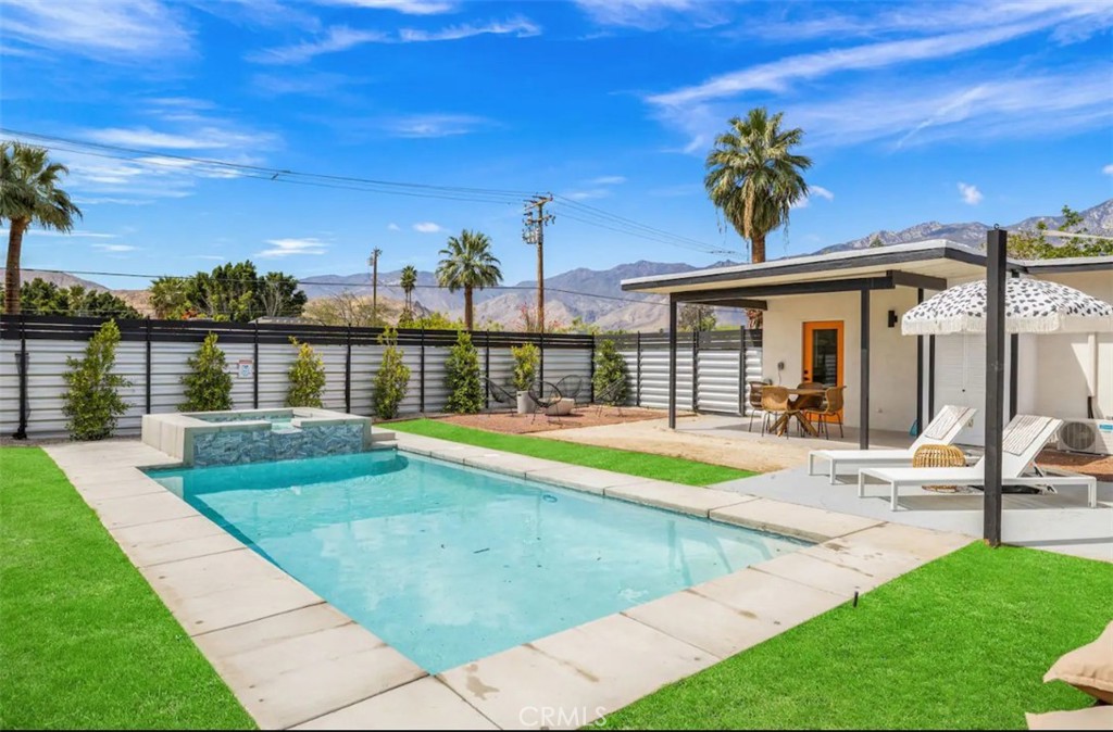 a view of a house with swimming pool and a yard