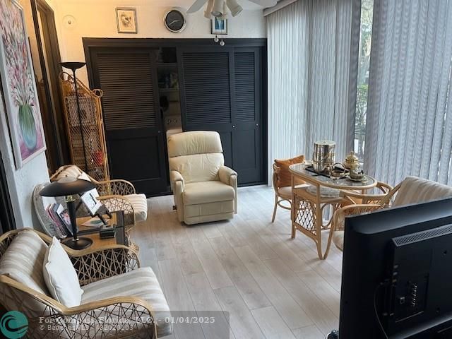 a reading room with furniture and wooden floor