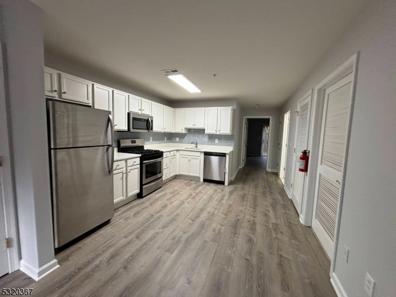 a kitchen with a refrigerator a sink and dishwasher