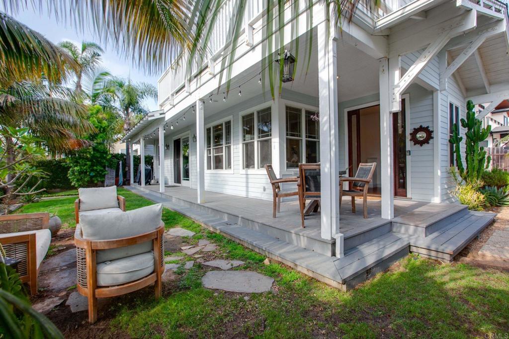 a view of a house with backyard and sitting area