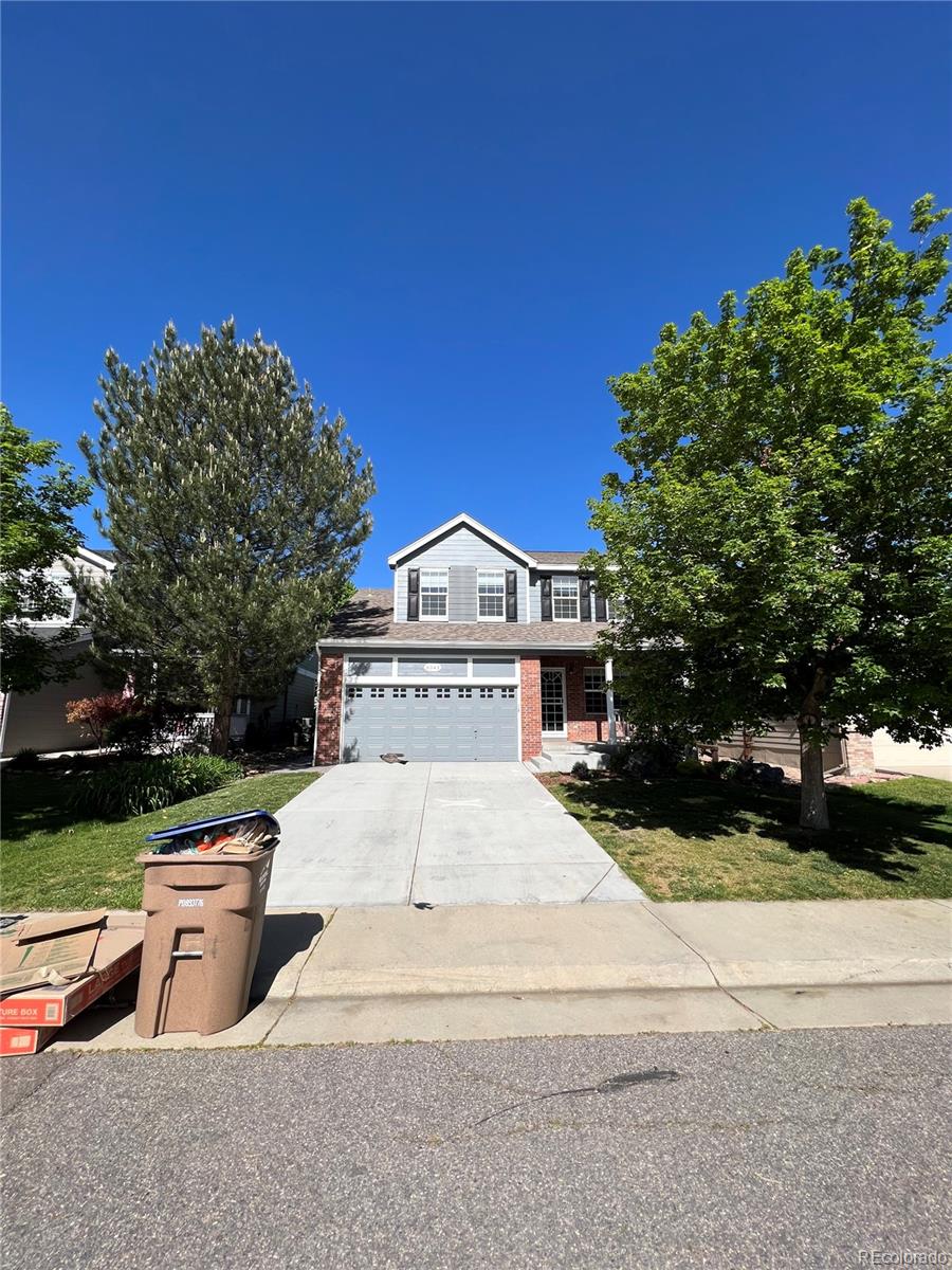 a view of a house with a yard and garage