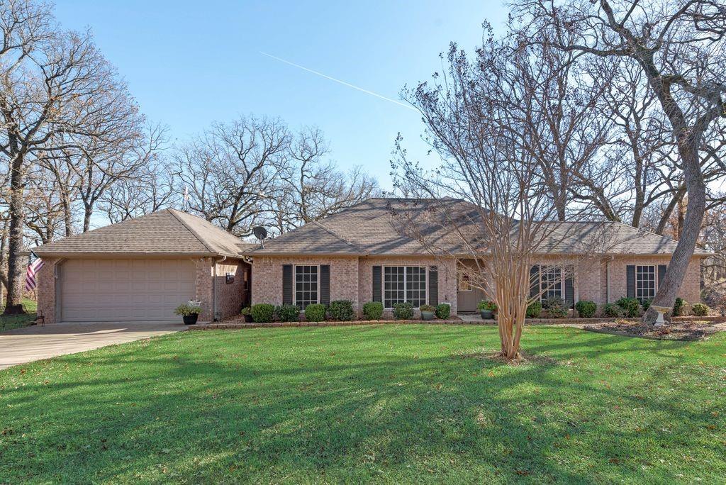 a front view of house with yard and green space