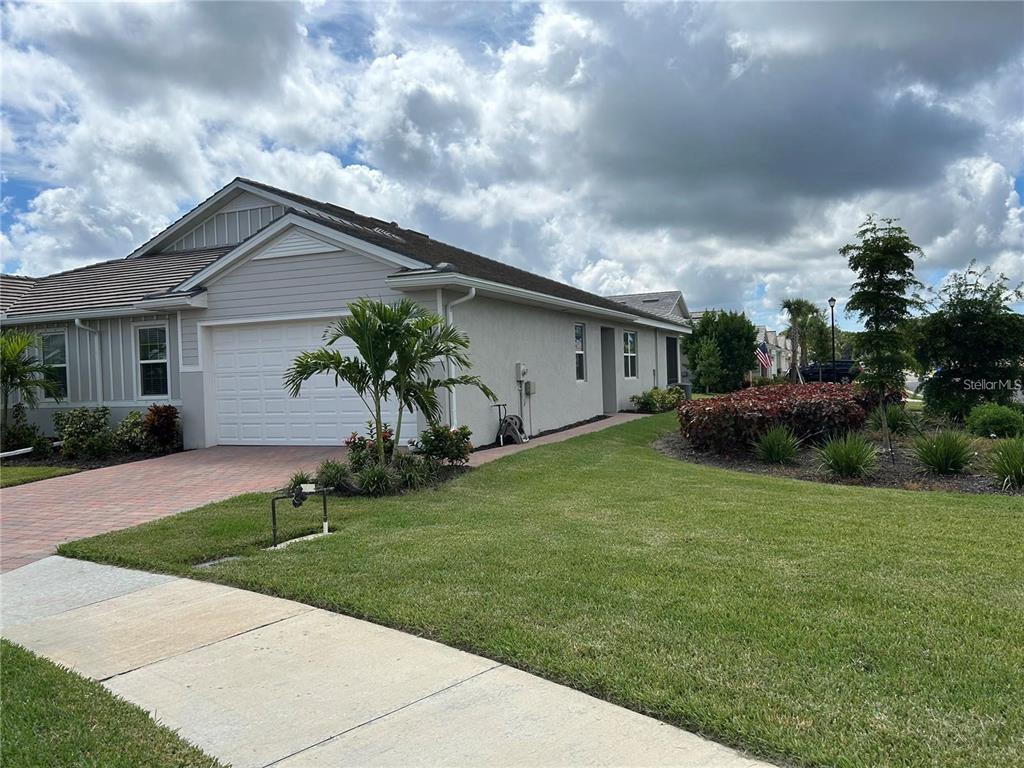 a front view of house with yard and green space