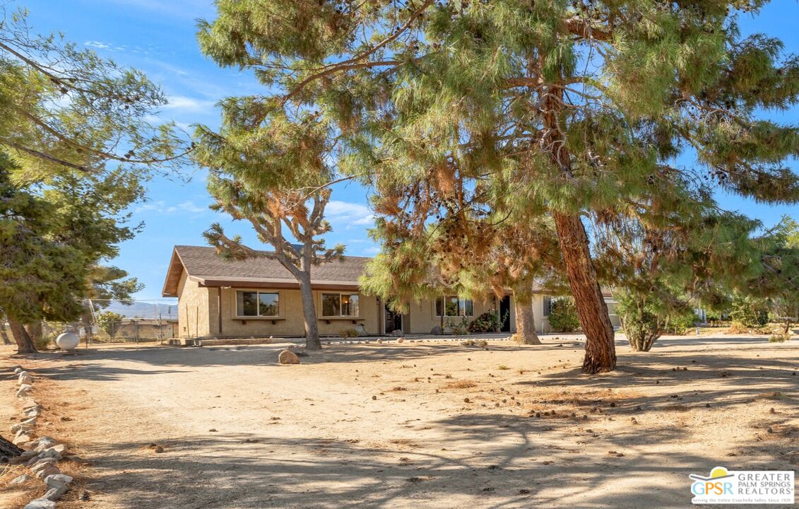 a house with trees in the background