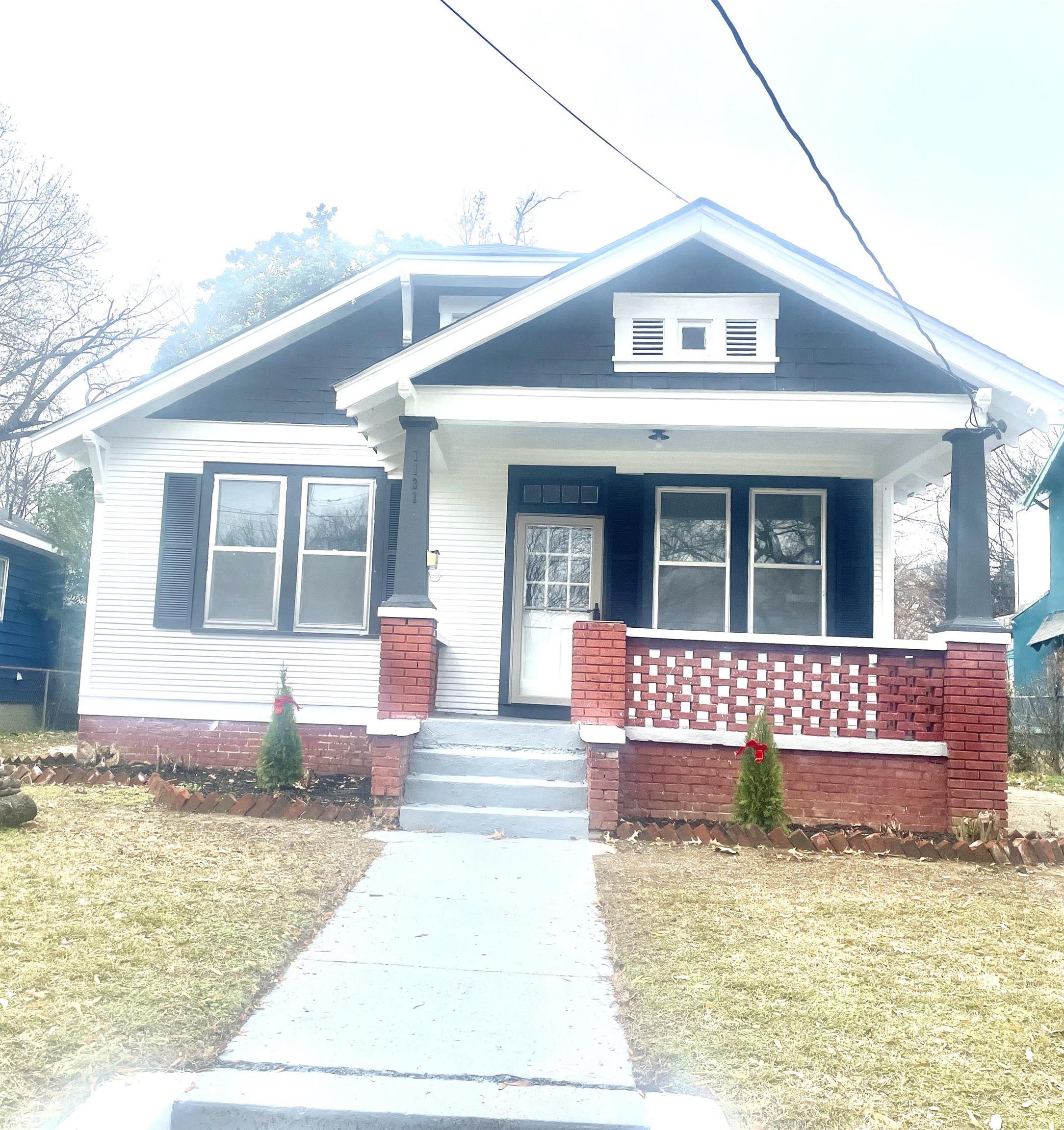 Bungalow-style home featuring a porch and a front yard