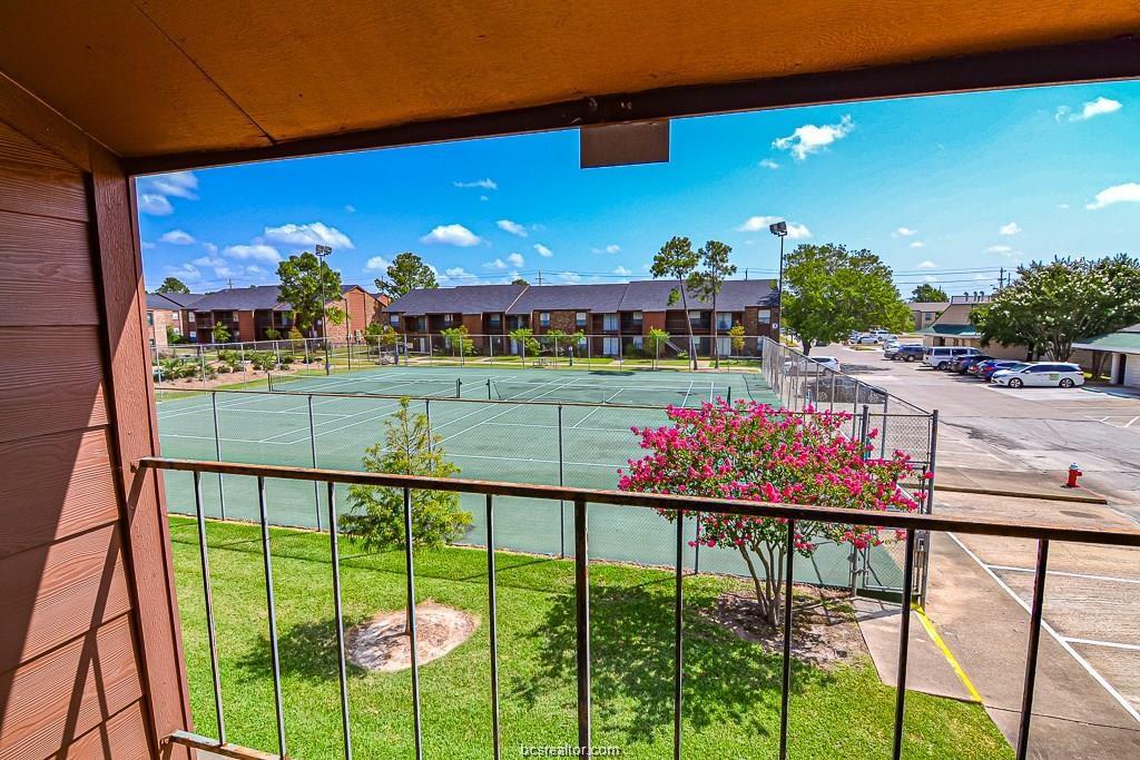 View of swimming pool with tennis court