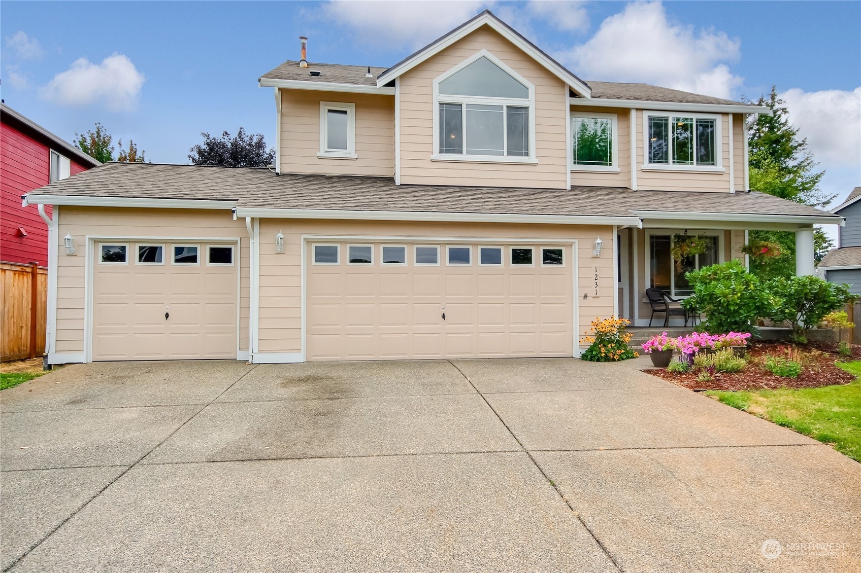 a view of a house with a yard and a garage