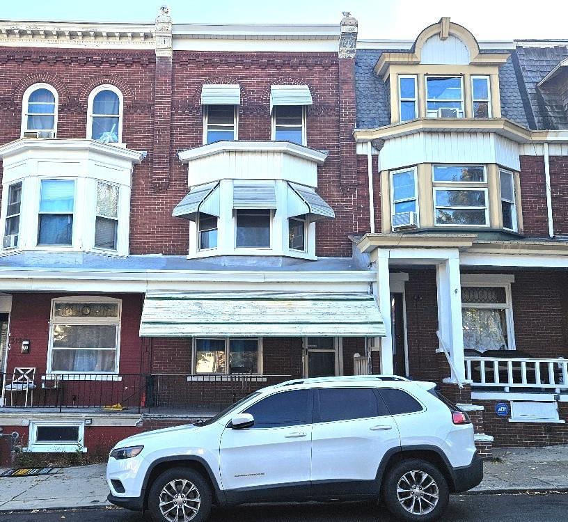 a front view of a house with parking space