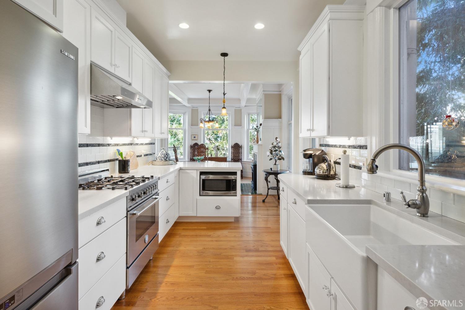 a kitchen with stainless steel appliances a sink stove and cabinets