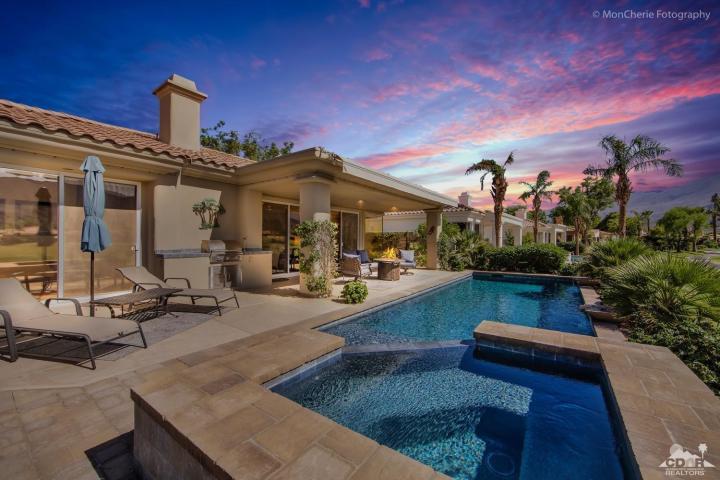 a view of a house with swimming pool and sitting area