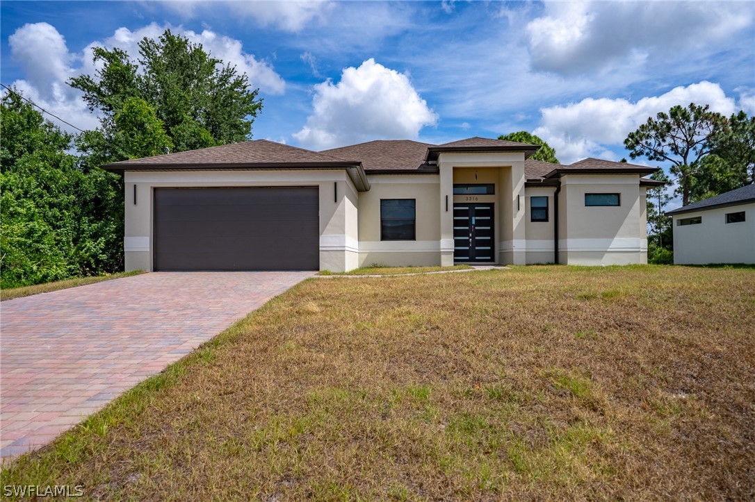 a front view of a house with a garden and yard