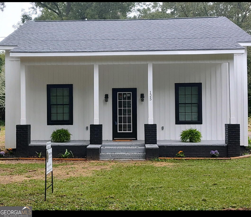 a front view of a house with garden