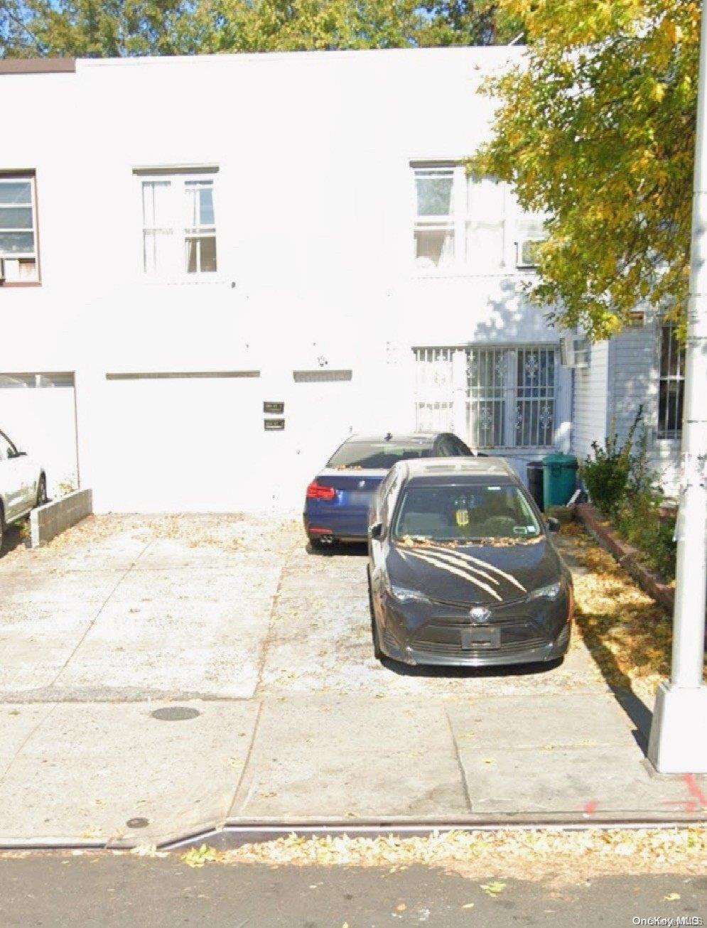 a white car parked in front of a building