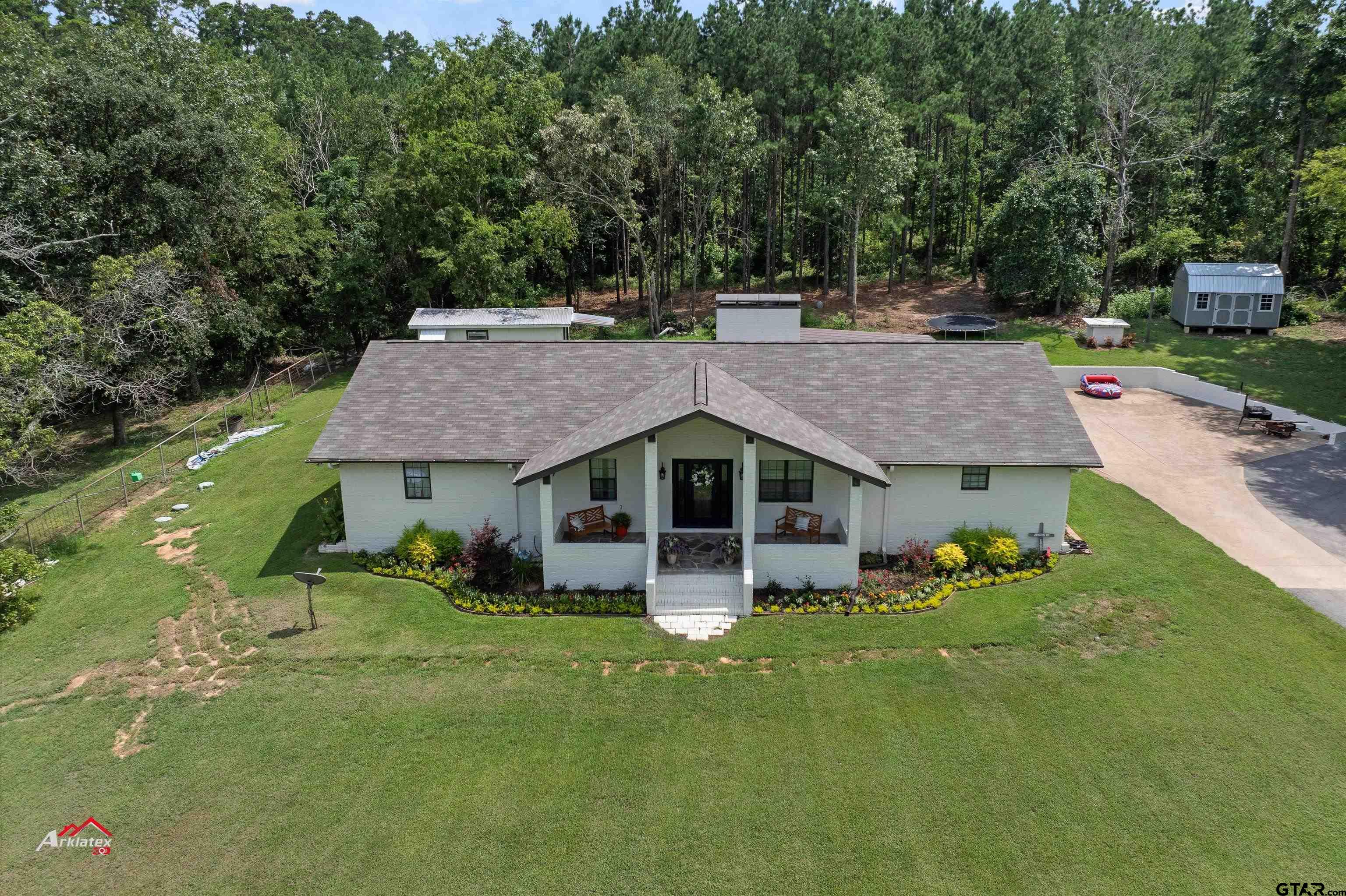 an aerial view of a house with pool table and chairs