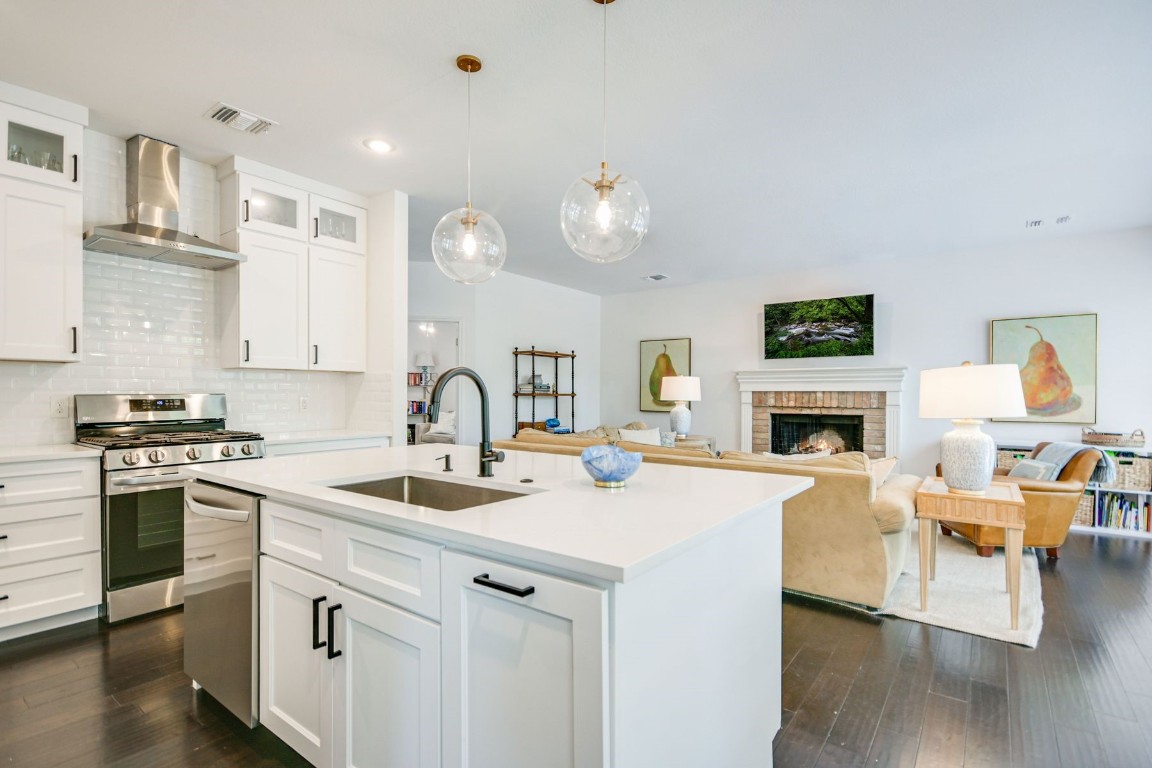 a kitchen with a stove a sink and a refrigerator