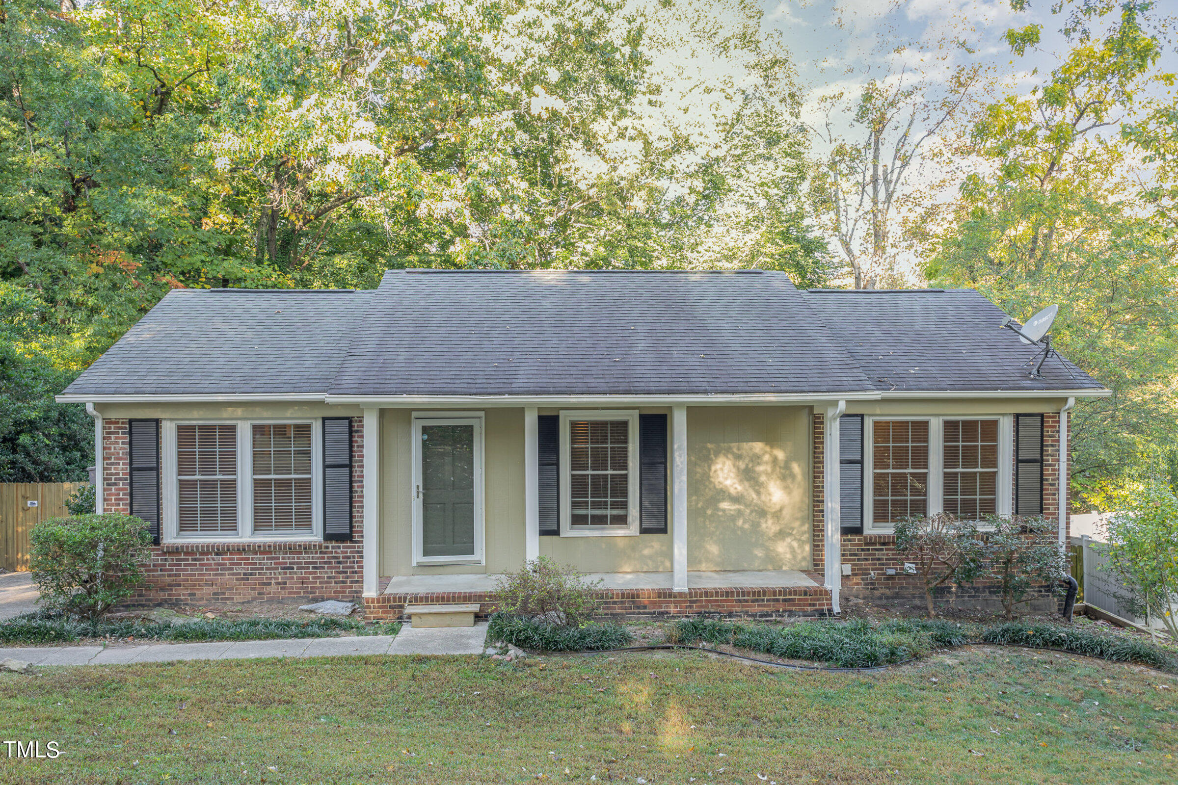 a front view of a house with yard and porch