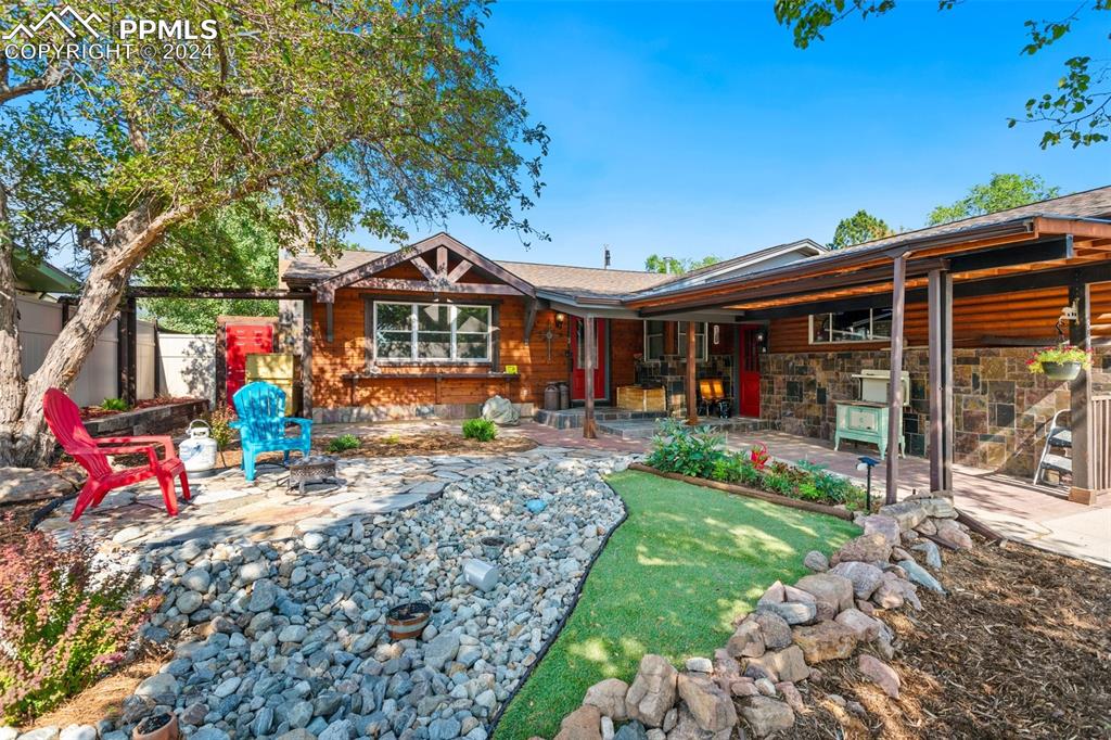 Front of house featuring a fire pit and a patio area