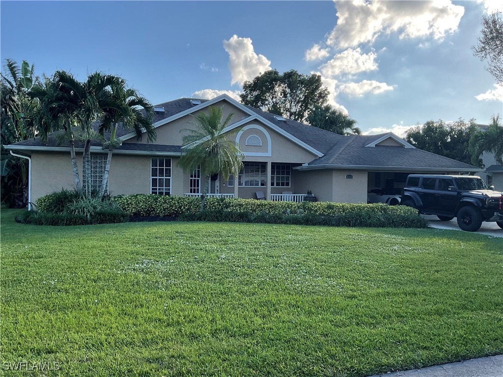 a front view of a house with a garden