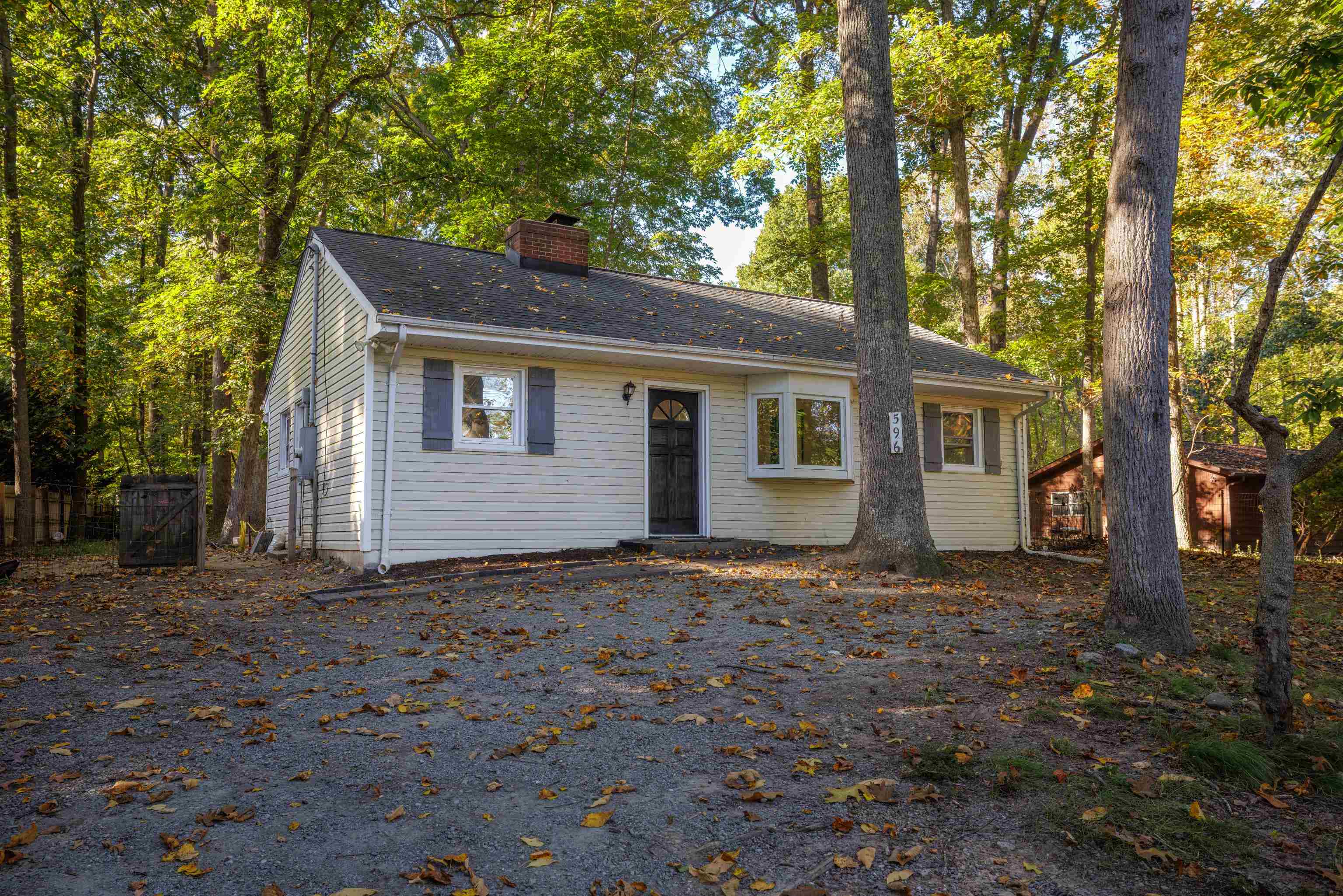 a backyard of a house with large trees