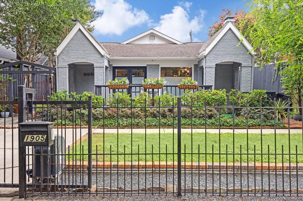 a front view of a house with a garden and plants