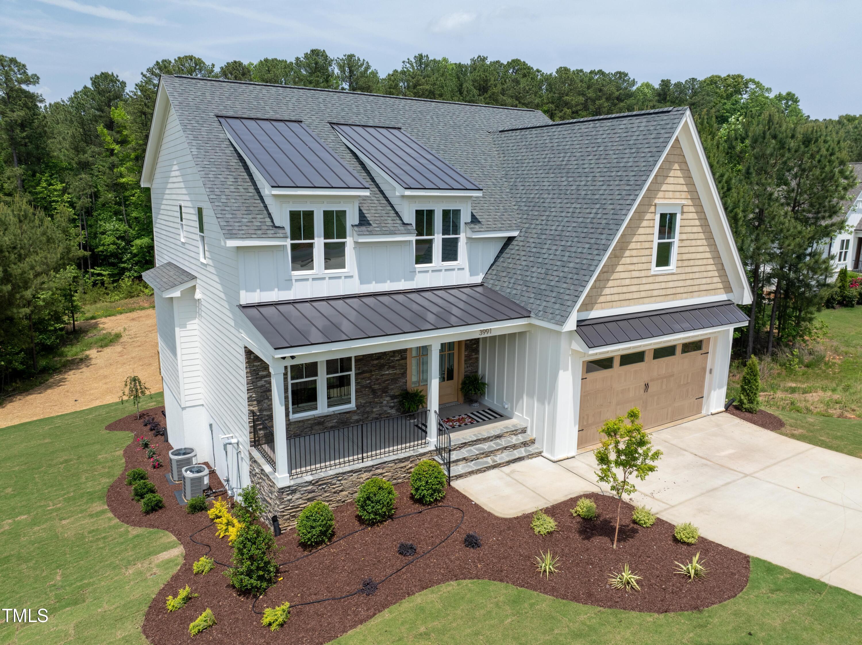 a aerial view of a house with yard and green space