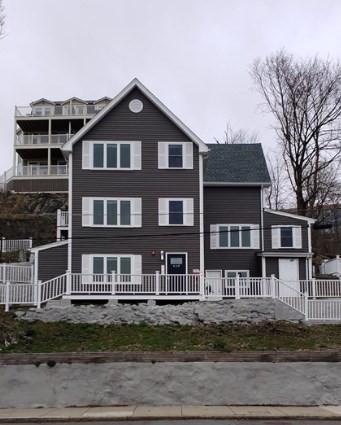 a front view of a house with a yard