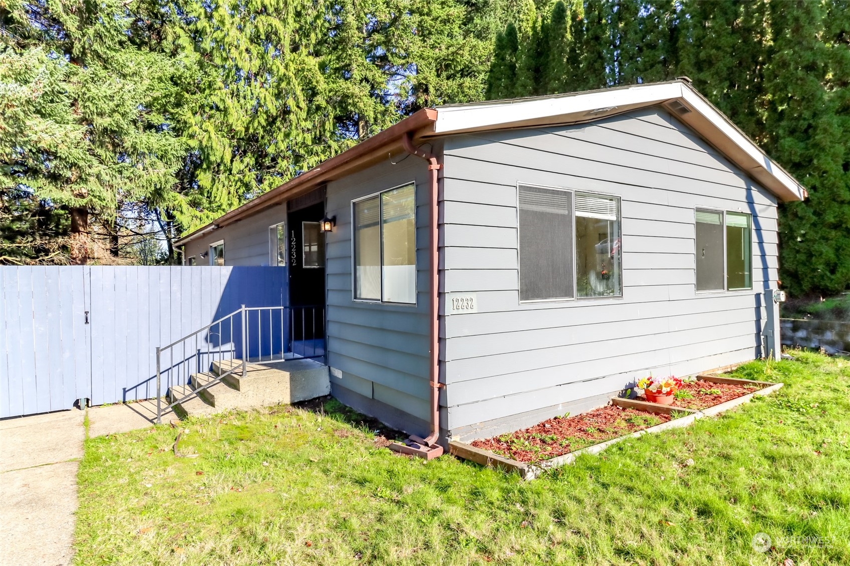 a view of a house with a backyard and wooden fence