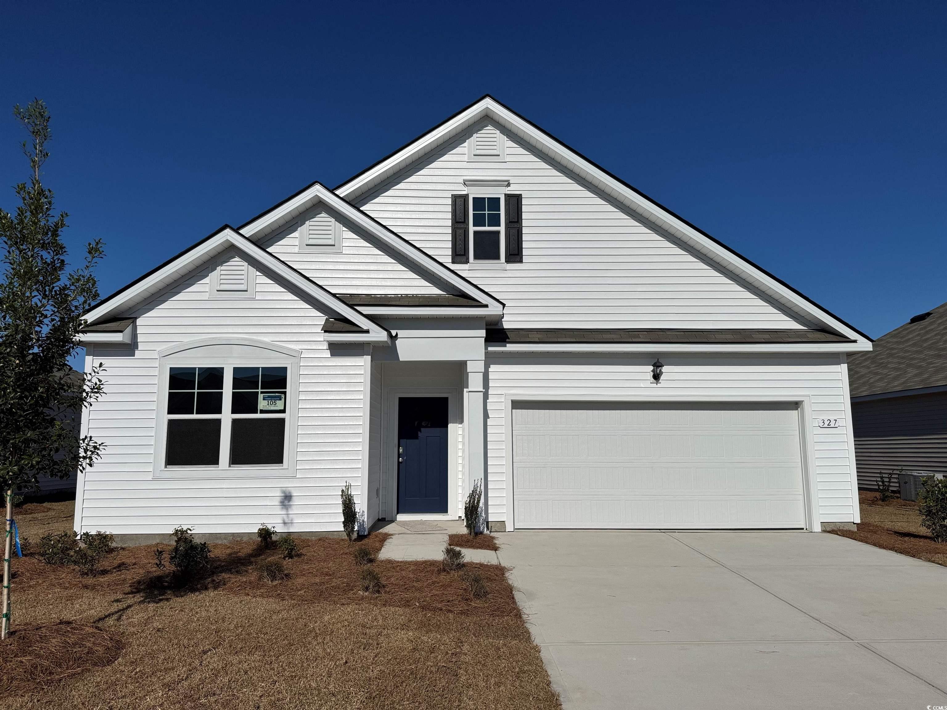 View of front of property featuring a garage