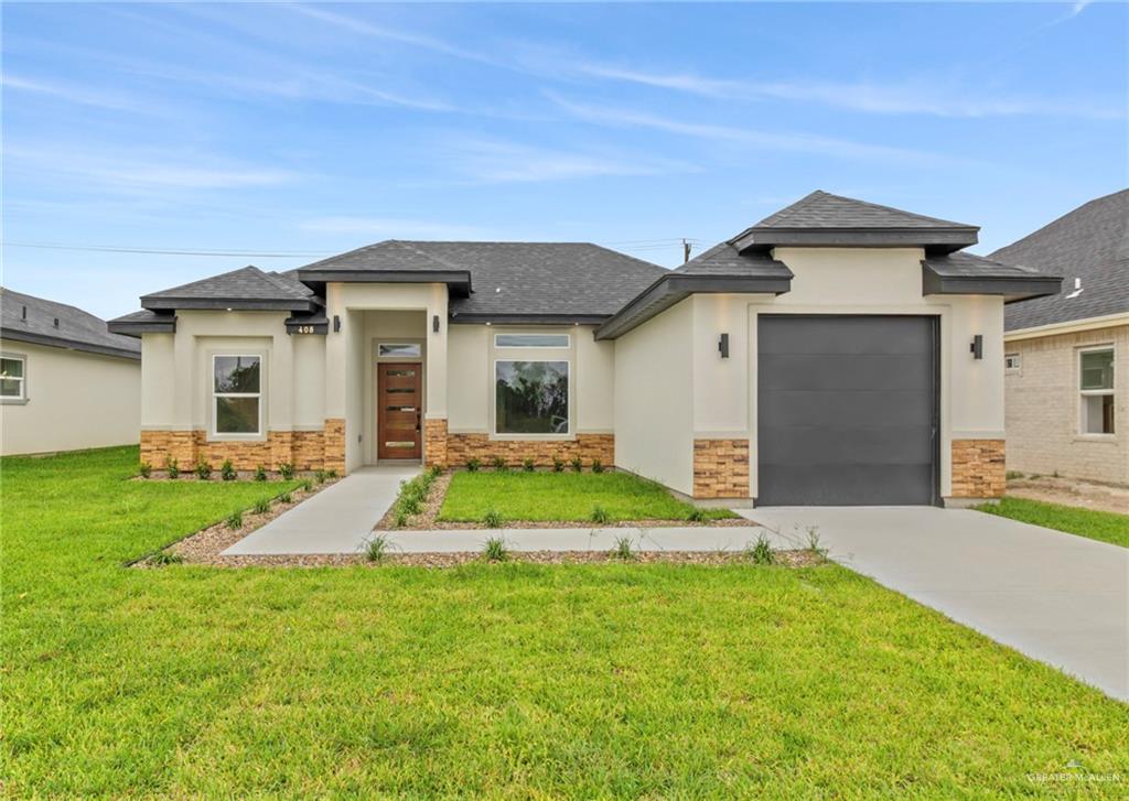 Prairie-style home with a garage and a front yard