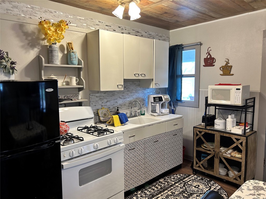 a kitchen with a stove and a refrigerator